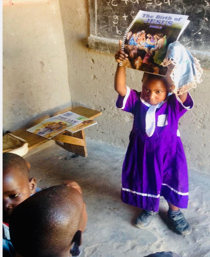 Ugandan girl with our book